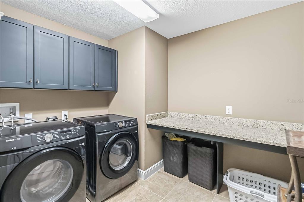 1004 Vinsetta Circle Winter Garden, FL 34787 - Photo 47 of 64 a utility room with sink dryer and washer