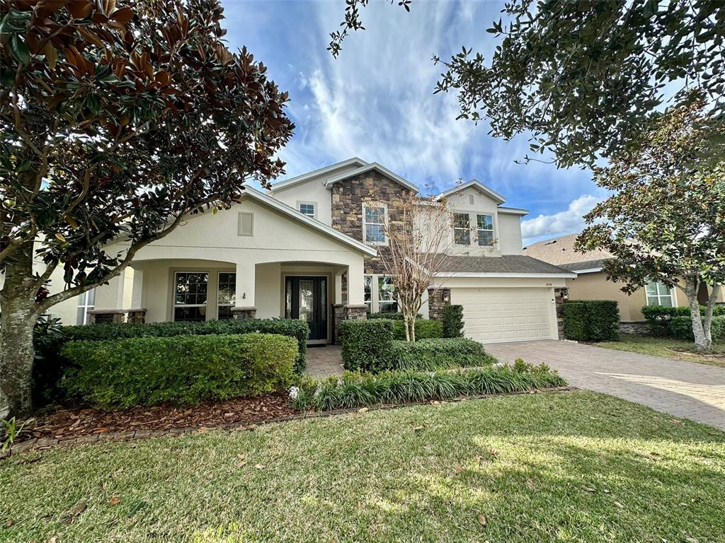 1004 Vinsetta Circle Winter Garden, FL 34787 - Photo 56 of 64 a front view of a house with a yard and trees
