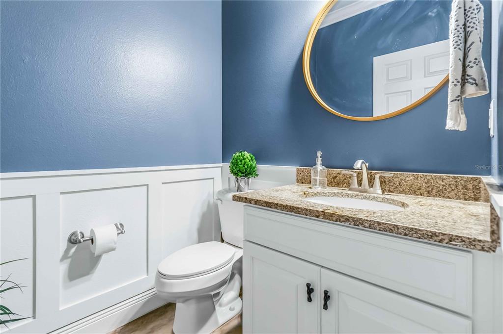 1004 Vinsetta Circle Winter Garden, FL 34787 - Photo 8 of 64 a bathroom with a granite countertop toilet sink and mirror
