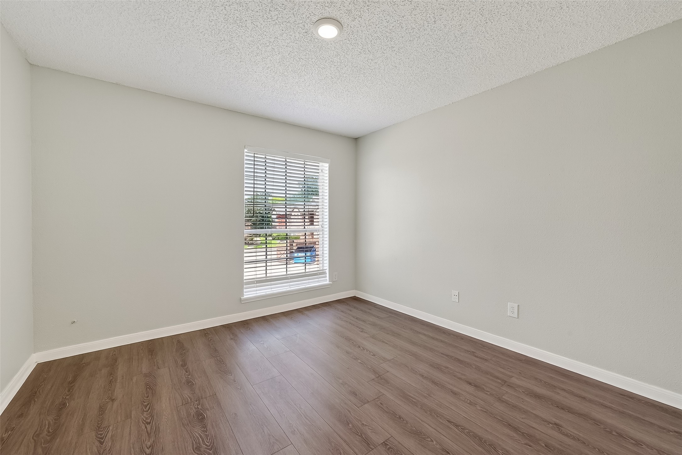 12200 Overbrook Lane, Unit 38D Houston, TX 77077 - Photo 11 of 20 an empty room with wooden floor and windows