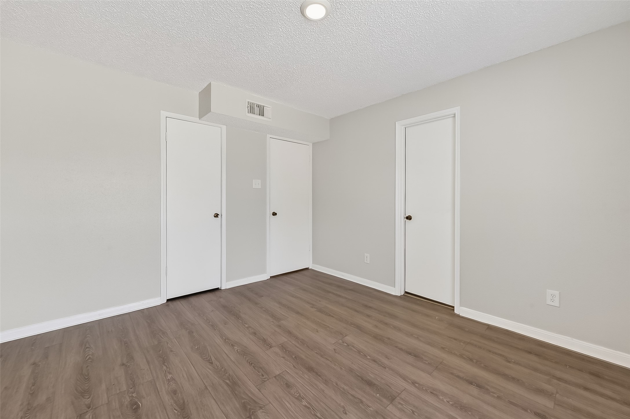 12200 Overbrook Lane, Unit 38D Houston, TX 77077 - Photo 12 of 20 a view of an empty room with wooden floor