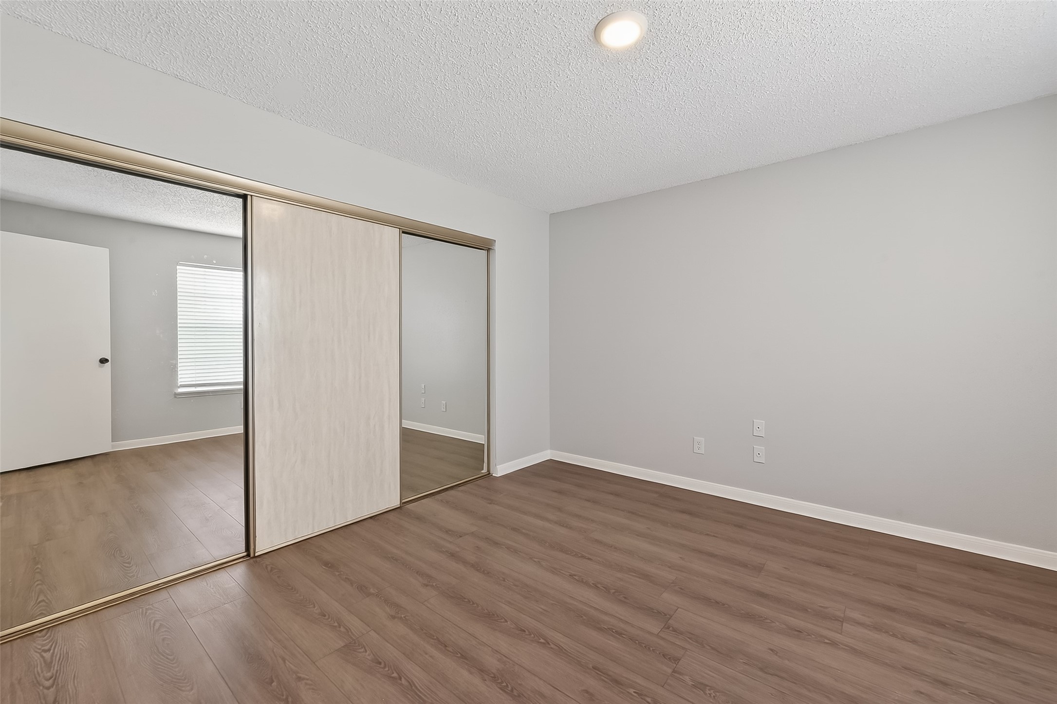12200 Overbrook Lane, Unit 38D Houston, TX 77077 - Photo 14 of 20 a view of an empty room with wooden floor