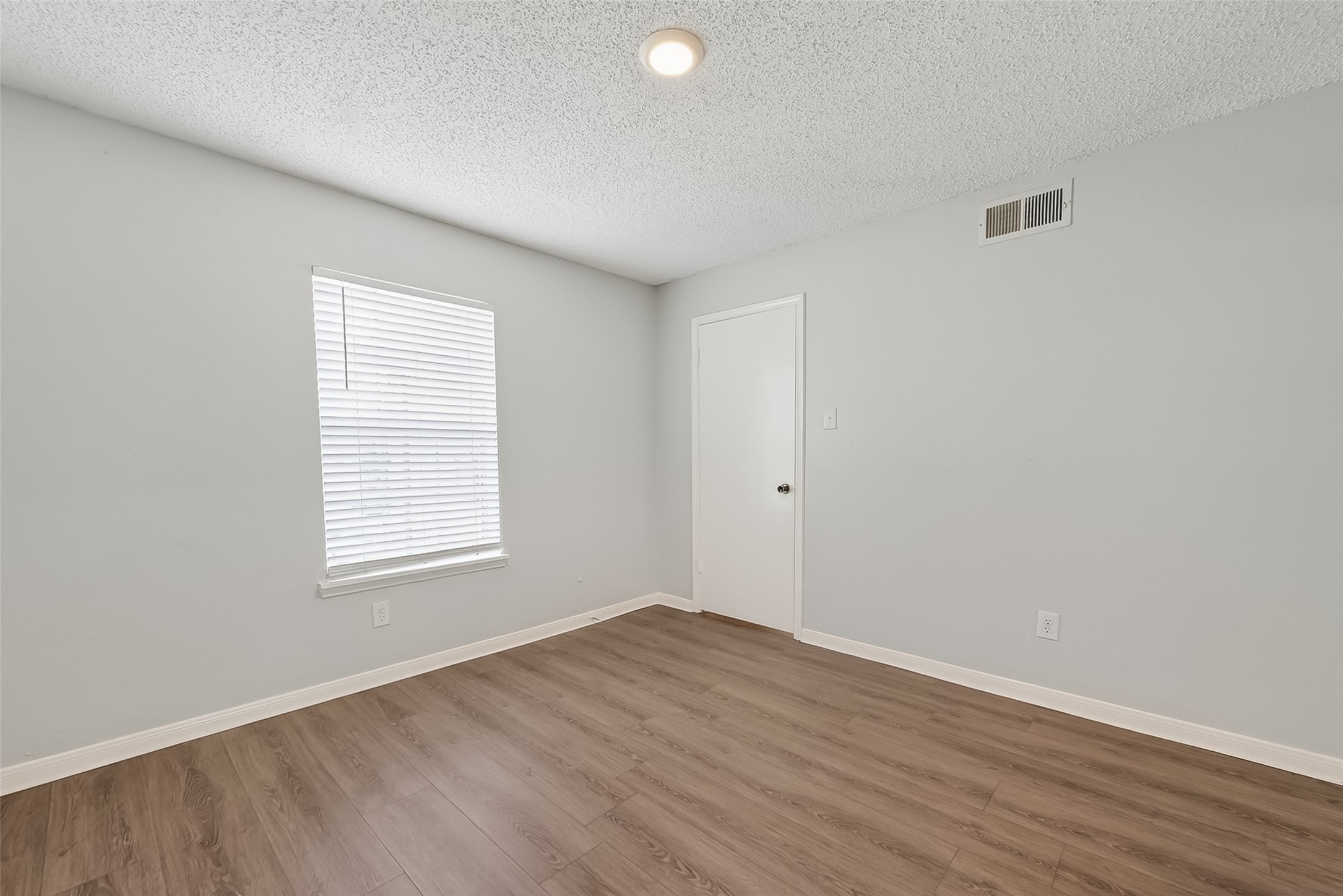 12200 Overbrook Lane, Unit 38D Houston, TX 77077 - Photo 15 of 20 an empty room with wooden floor and windows