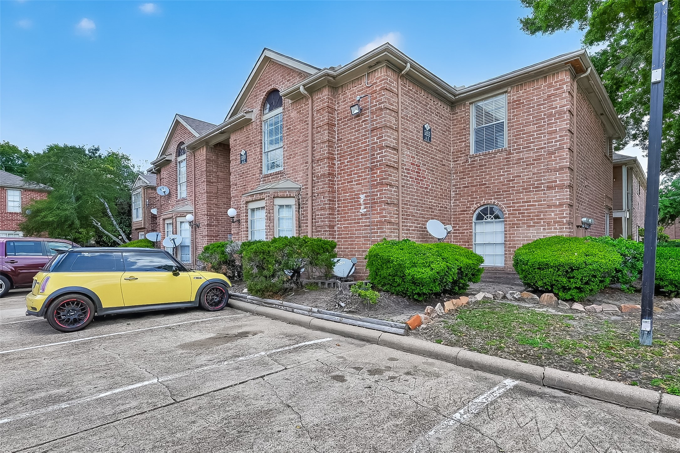 12200 Overbrook Lane, Unit 38D Houston, TX 77077 - Photo 2 of 20 a car parked in front of a brick house