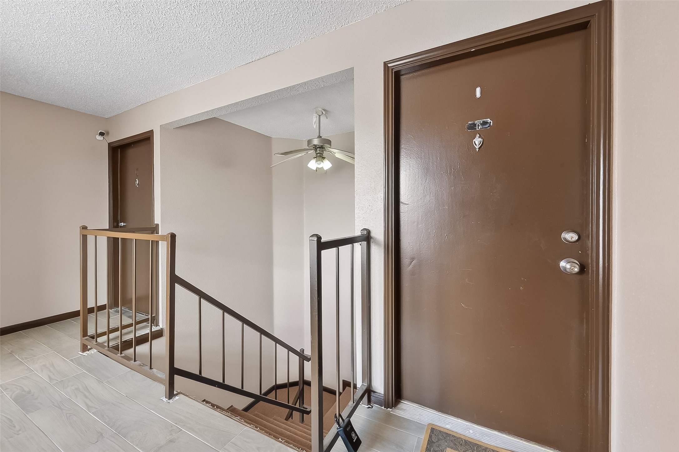 12200 Overbrook Lane, Unit 38D Houston, TX 77077 - Photo 4 of 20 a view of a hallway with wooden floor and staircase