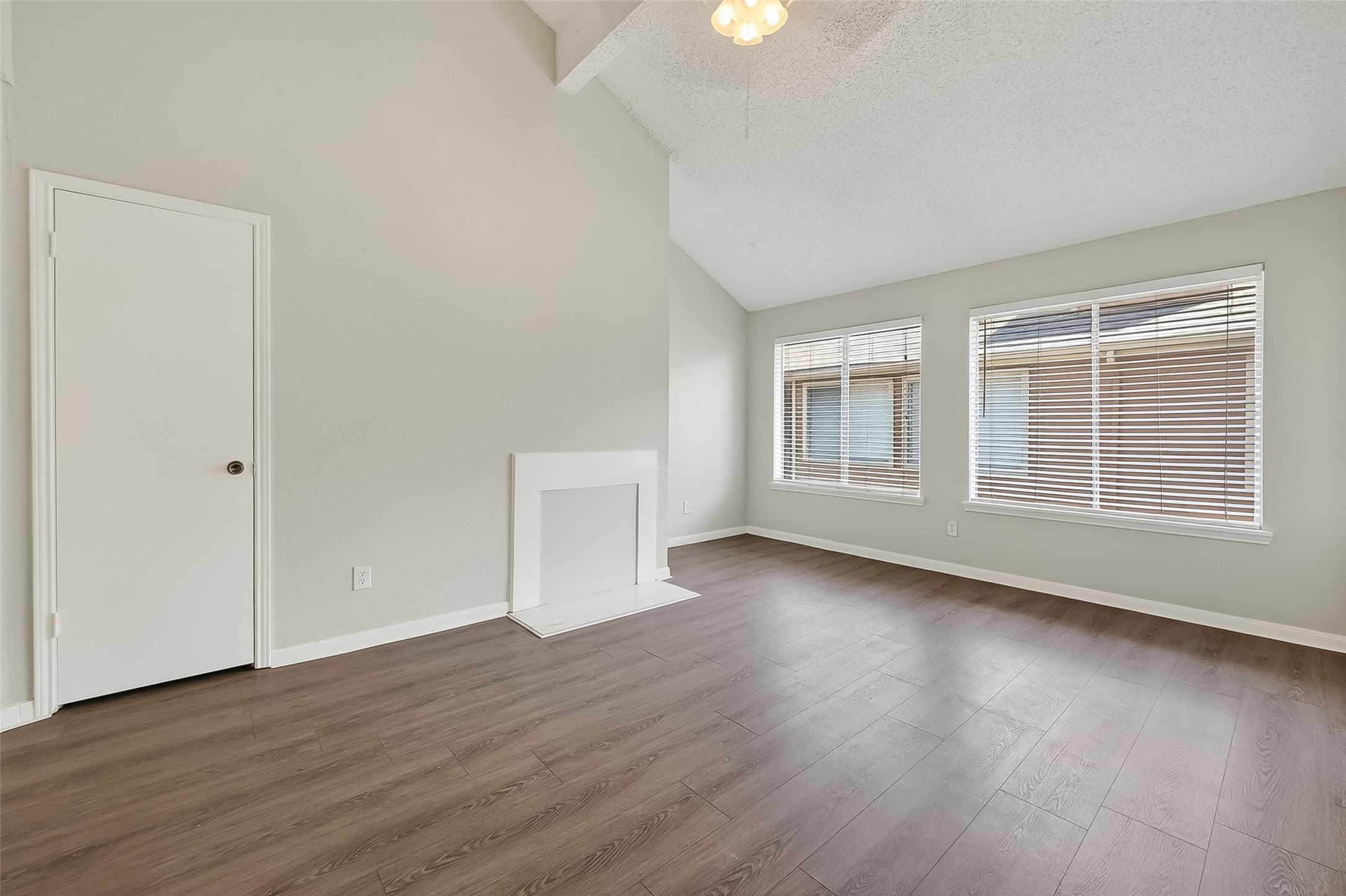 12200 Overbrook Lane, Unit 38D Houston, TX 77077 - Photo 7 of 20 a view of an empty room with wooden floor and windows
