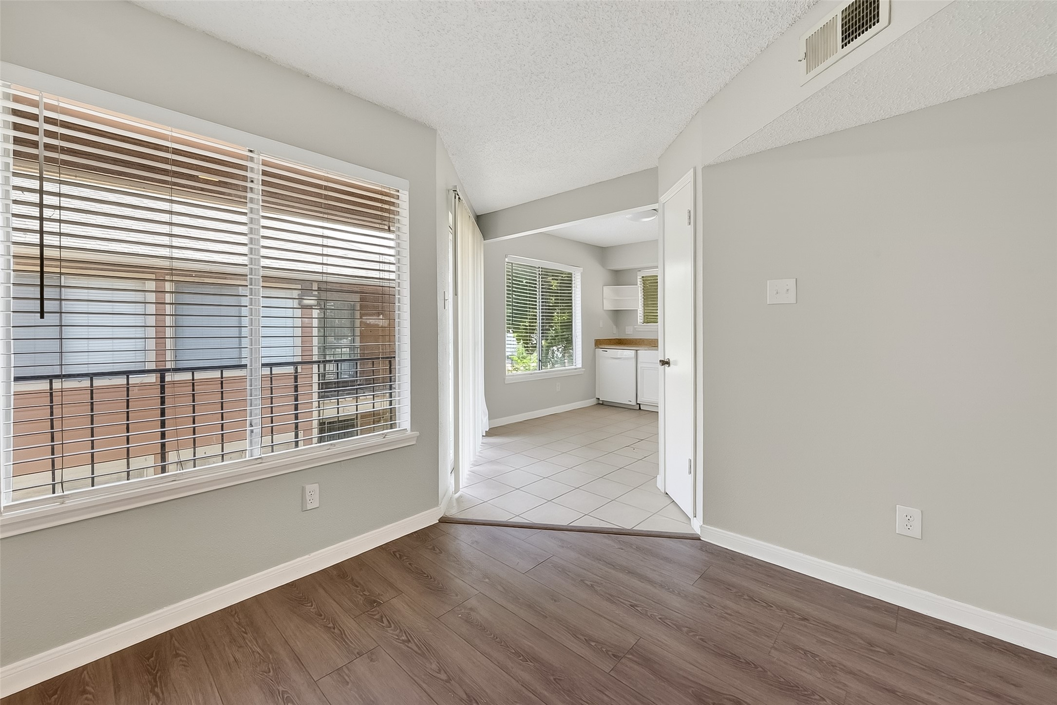 12200 Overbrook Lane, Unit 38D Houston, TX 77077 - Photo 8 of 20 a view of an empty room with wooden floor and a window