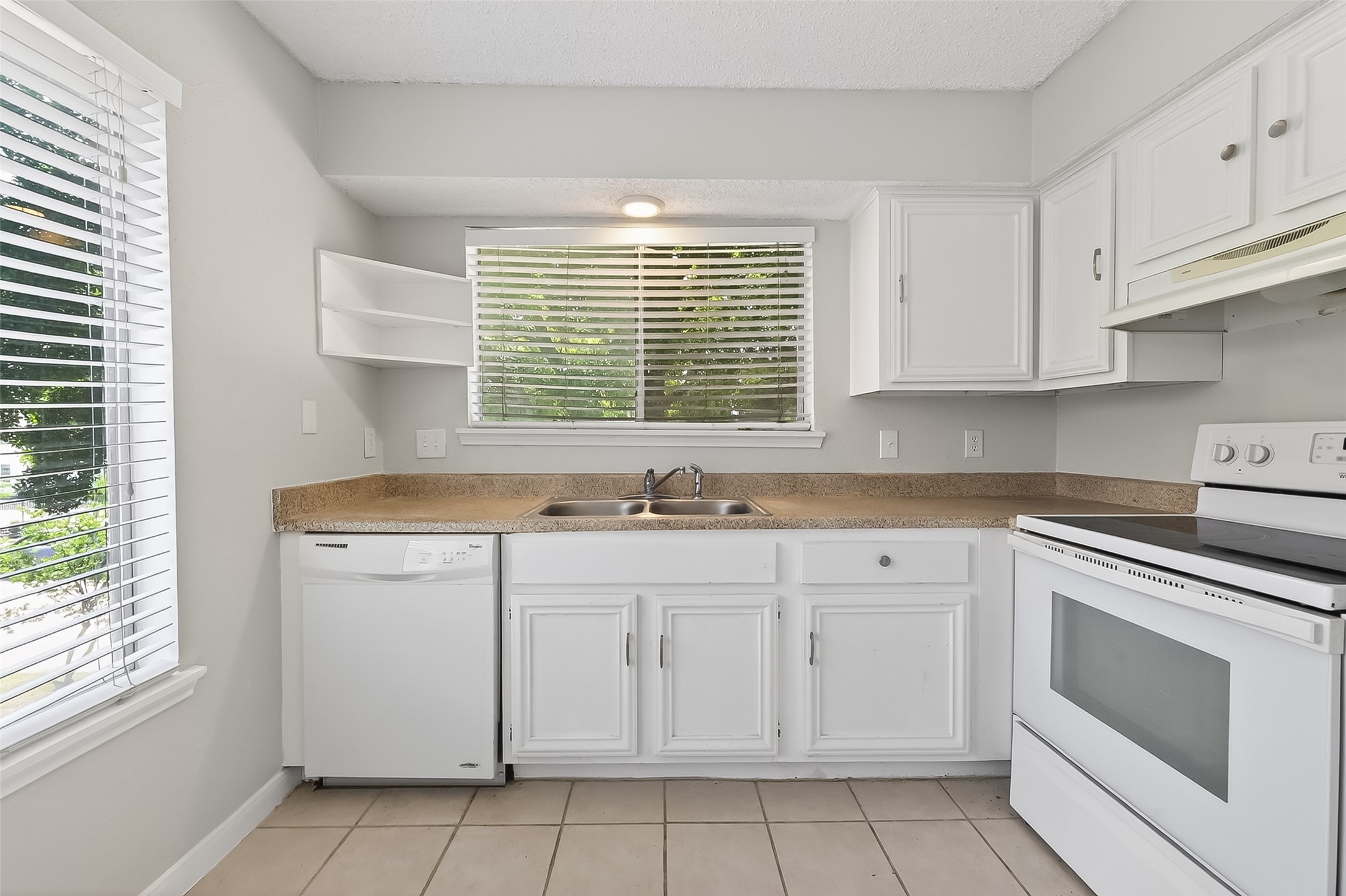 12200 Overbrook Lane, Unit 38D Houston, TX 77077 - Photo 9 of 20 a kitchen with granite countertop white cabinets and white appliances