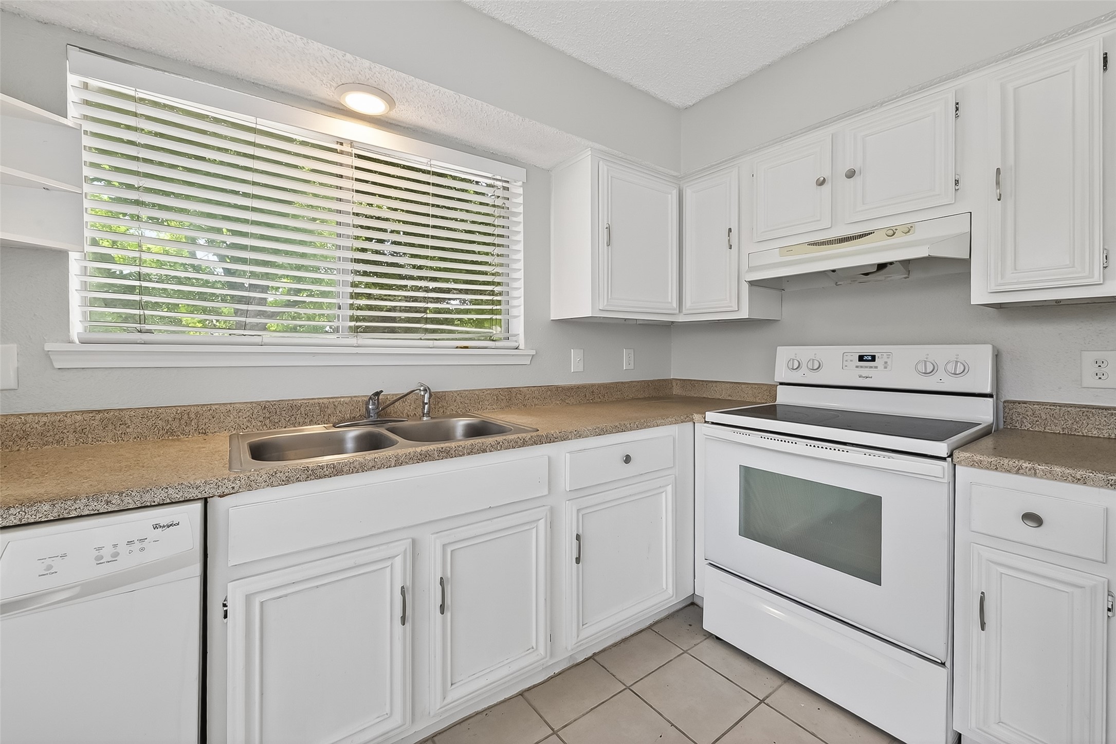 12200 Overbrook Lane, Unit 38D Houston, TX 77077 - Photo 10 of 20 a kitchen with granite countertop white cabinets and white appliances