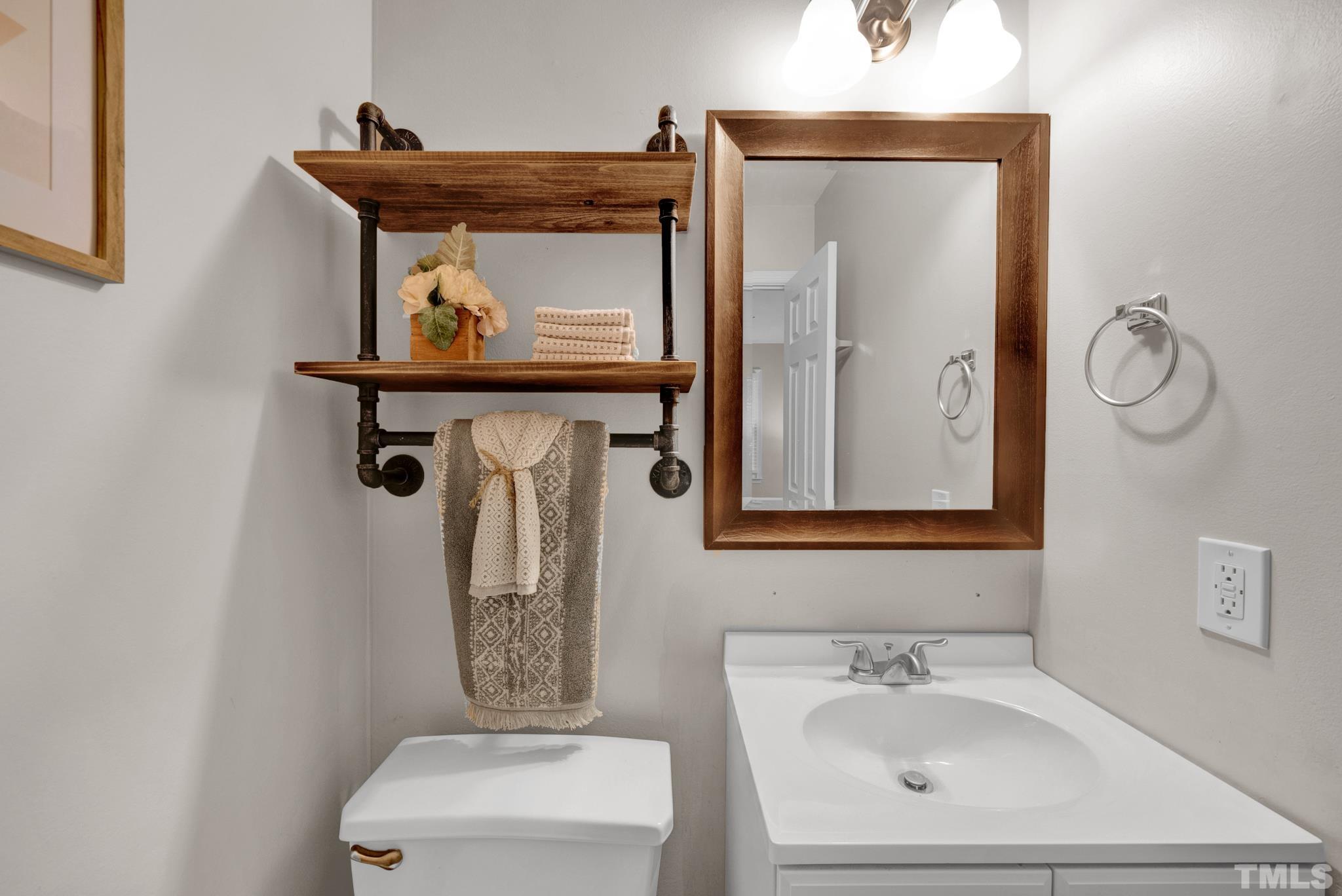1113 Mockingbird Drive Raleigh, NC 27615 - Photo 20 of 25 a bathroom with a toilet a sink and mirror
