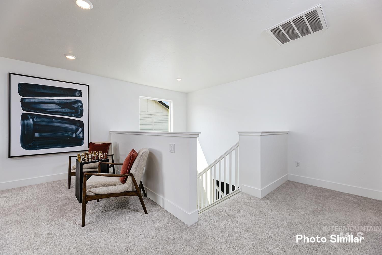 9331 West Inspirado Street Meridian, ID 83646 - Photo 24 of 34 Sitting room with an upstairs landing, light colored carpet, and recessed lighting