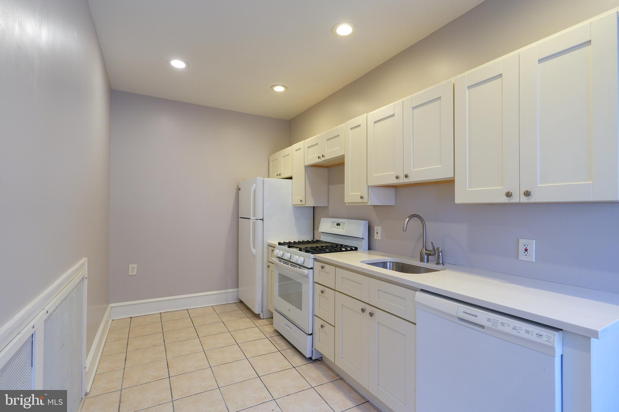 1601 Jackson Street, Unit 1 Philadelphia, PA 19145 - Photo 3 of 16 a kitchen with a sink a stove and cabinets