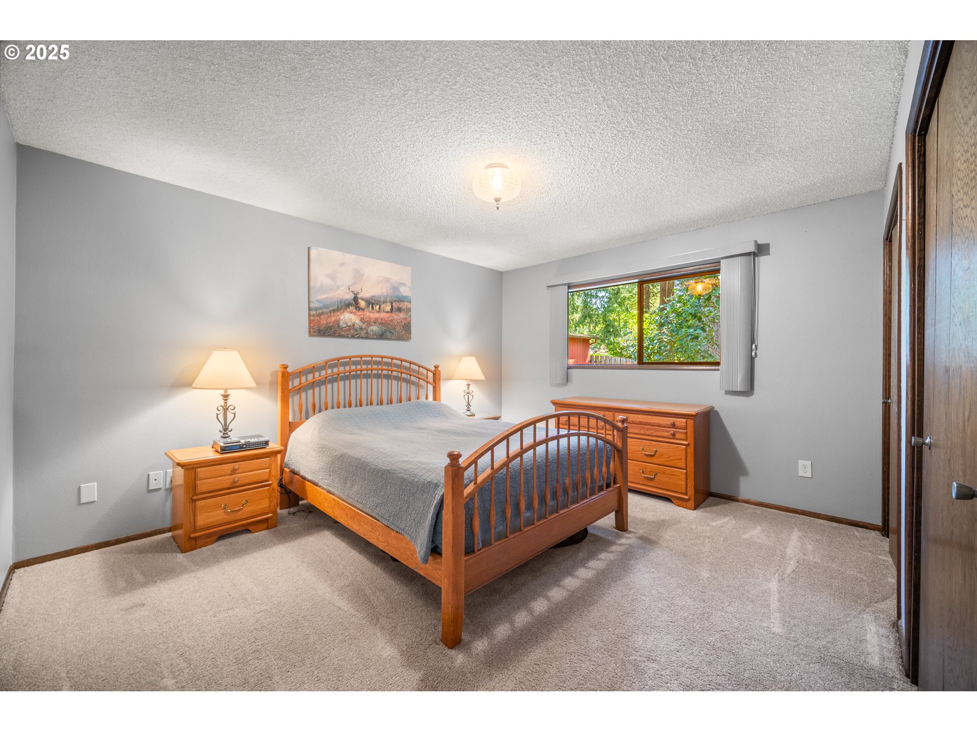 9420 Southeast Carnaby Way Happy Valley, OR 97086 - Photo 17 of 43 a bedroom with a bed and window