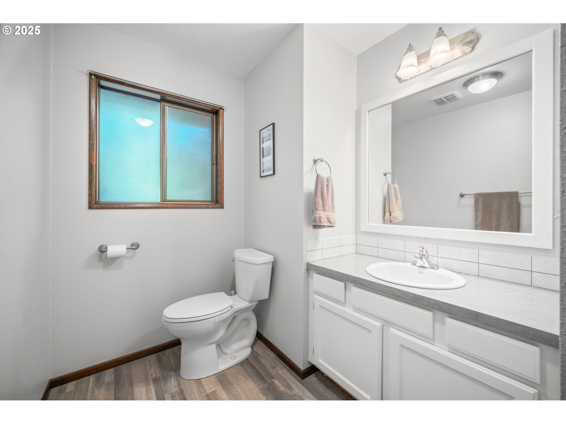 9420 Southeast Carnaby Way Happy Valley, OR 97086 - Photo 19 of 43 a bathroom with a toilet sink and mirror