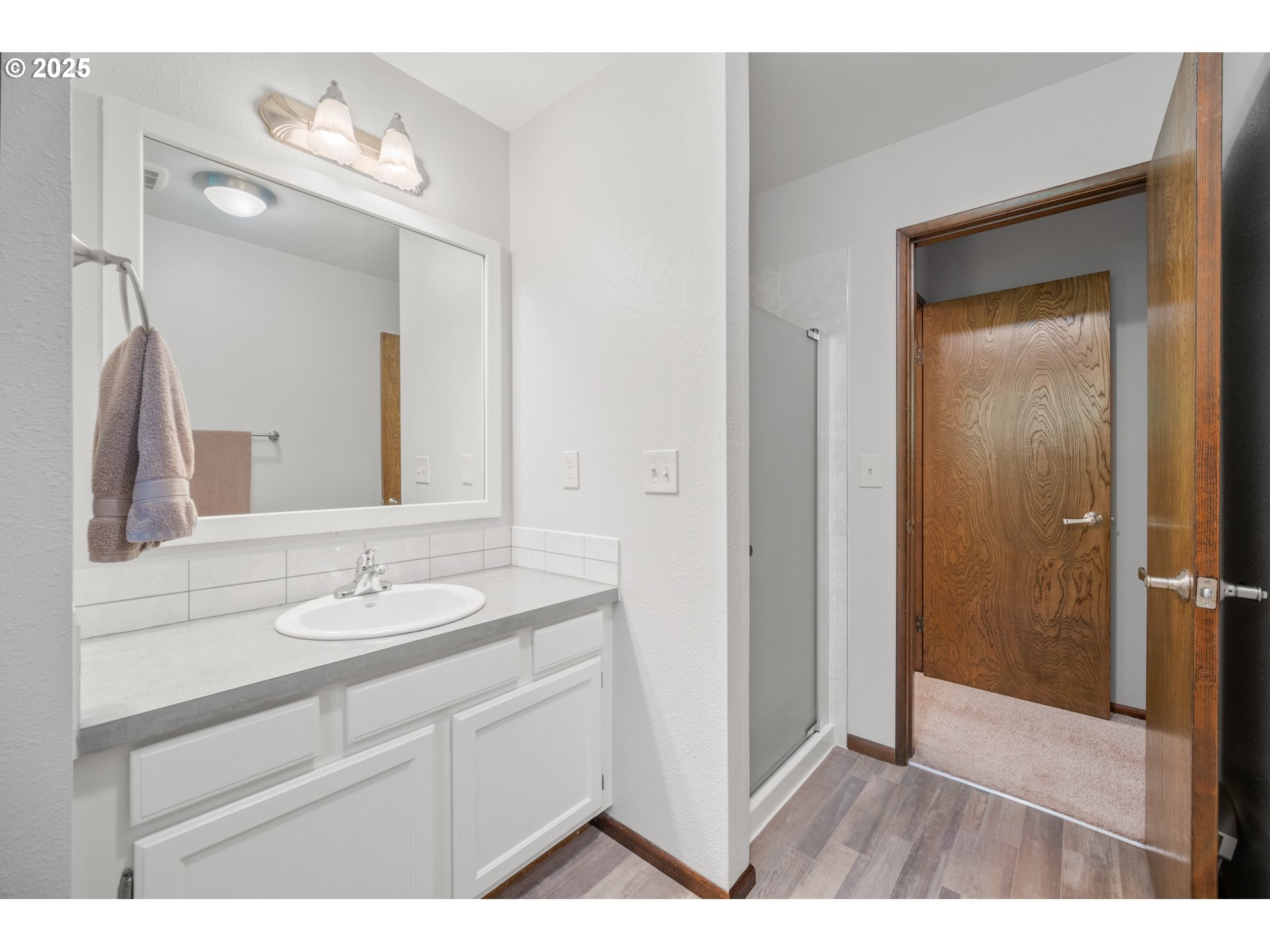 9420 Southeast Carnaby Way Happy Valley, OR 97086 - Photo 20 of 43 a bathroom with a sink a mirror and a shower