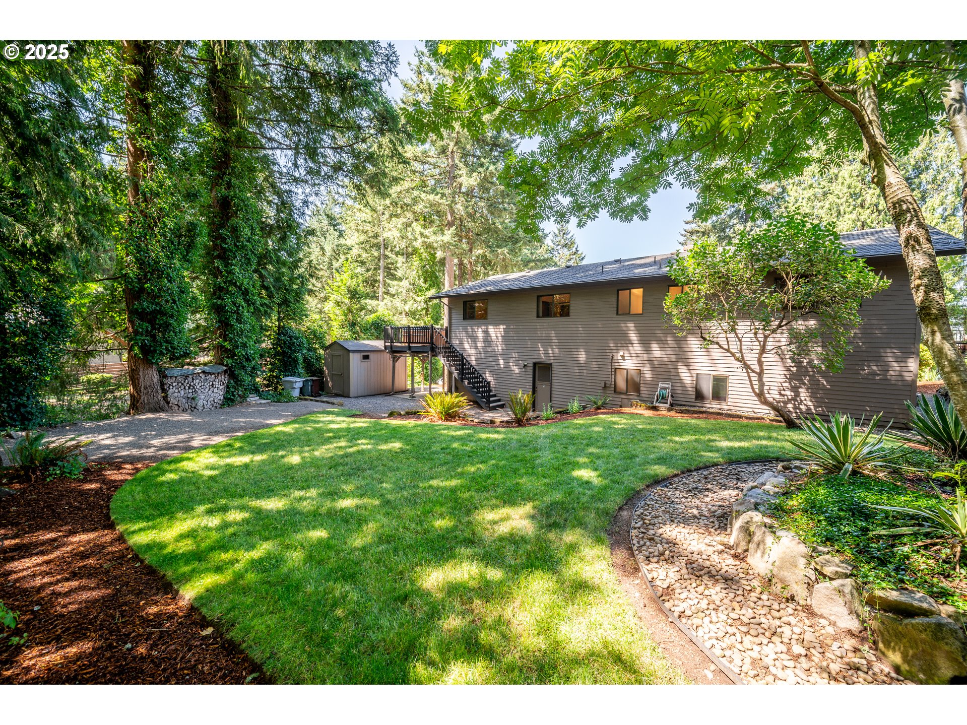 9420 Southeast Carnaby Way Happy Valley, OR 97086 - Photo 33 of 43 a view of a backyard with table and chairs and potted plants