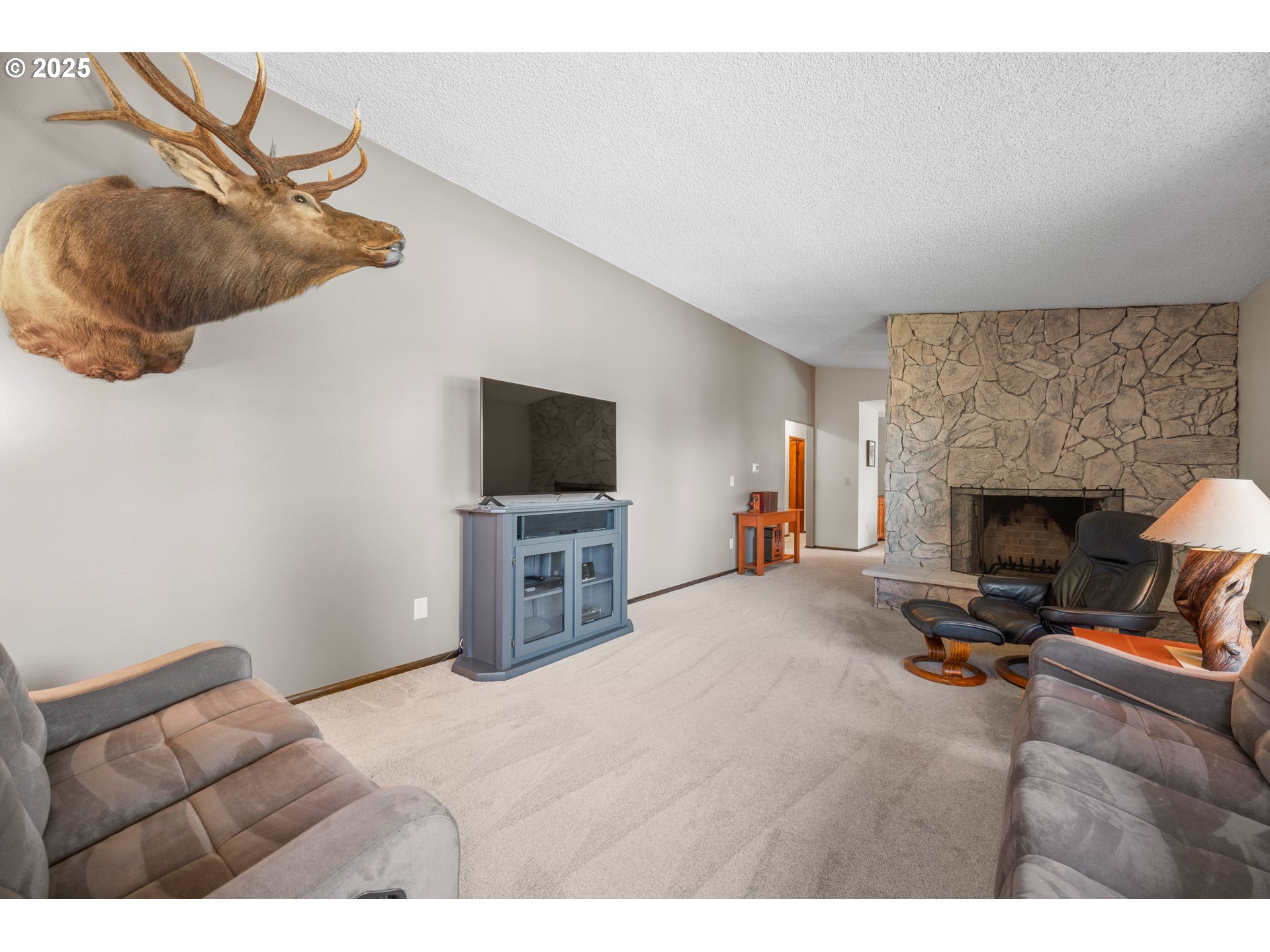 9420 Southeast Carnaby Way Happy Valley, OR 97086 - Photo 6 of 43 a living room with furniture and a fireplace