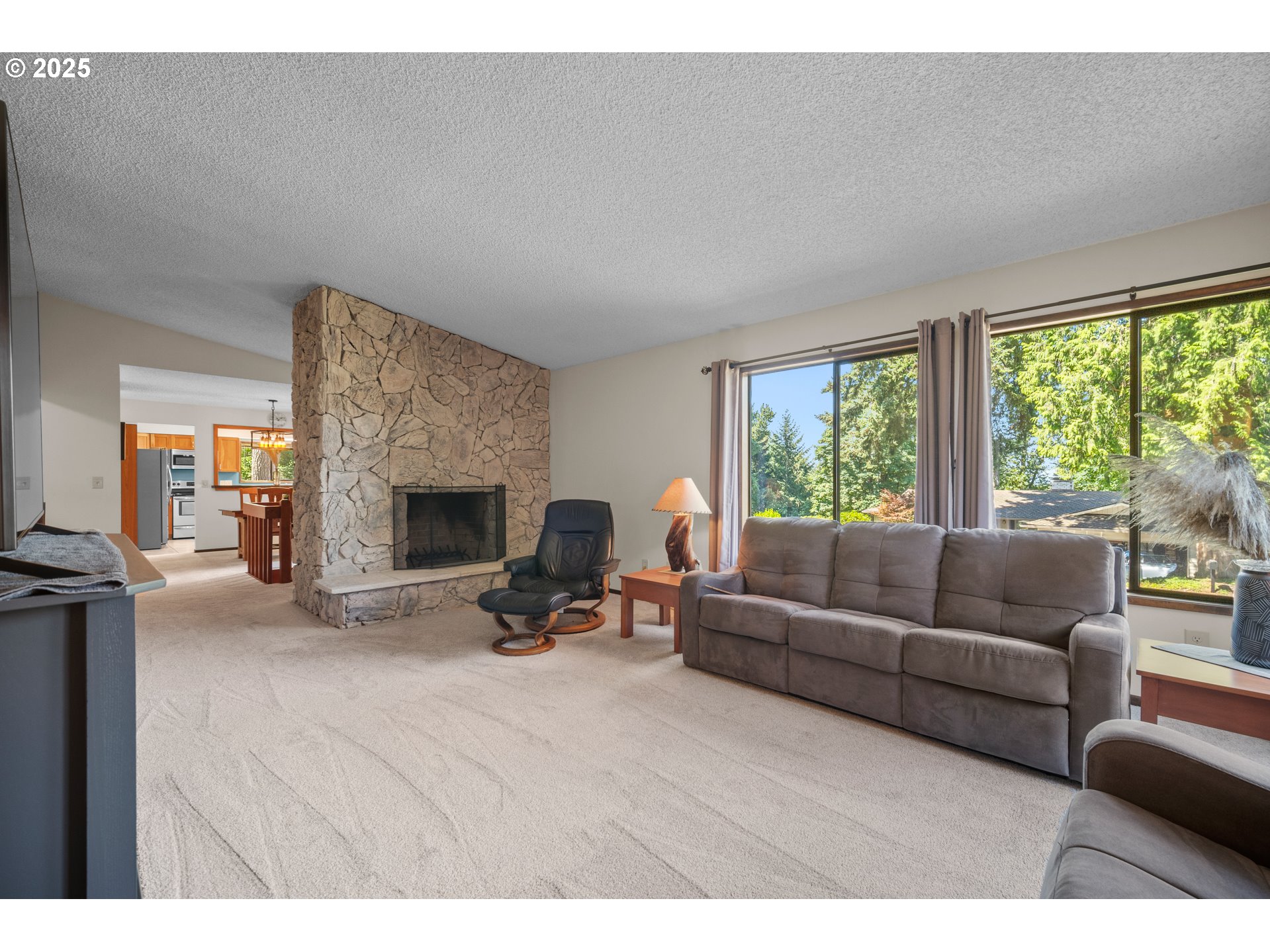 9420 Southeast Carnaby Way Happy Valley, OR 97086 - Photo 7 of 43 a living room with furniture and a fireplace