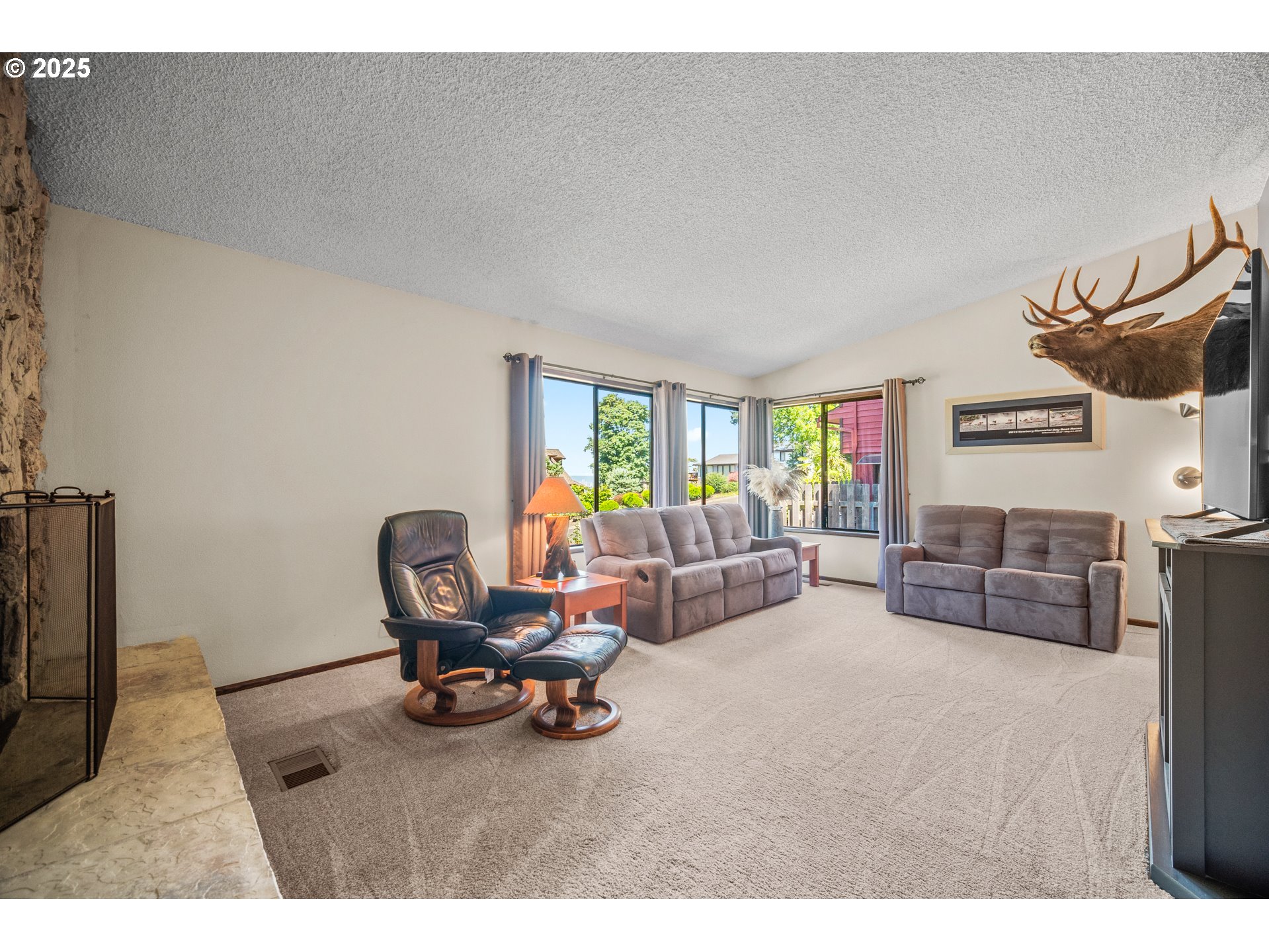 9420 Southeast Carnaby Way Happy Valley, OR 97086 - Photo 8 of 43 a living room with furniture and a wooden floor