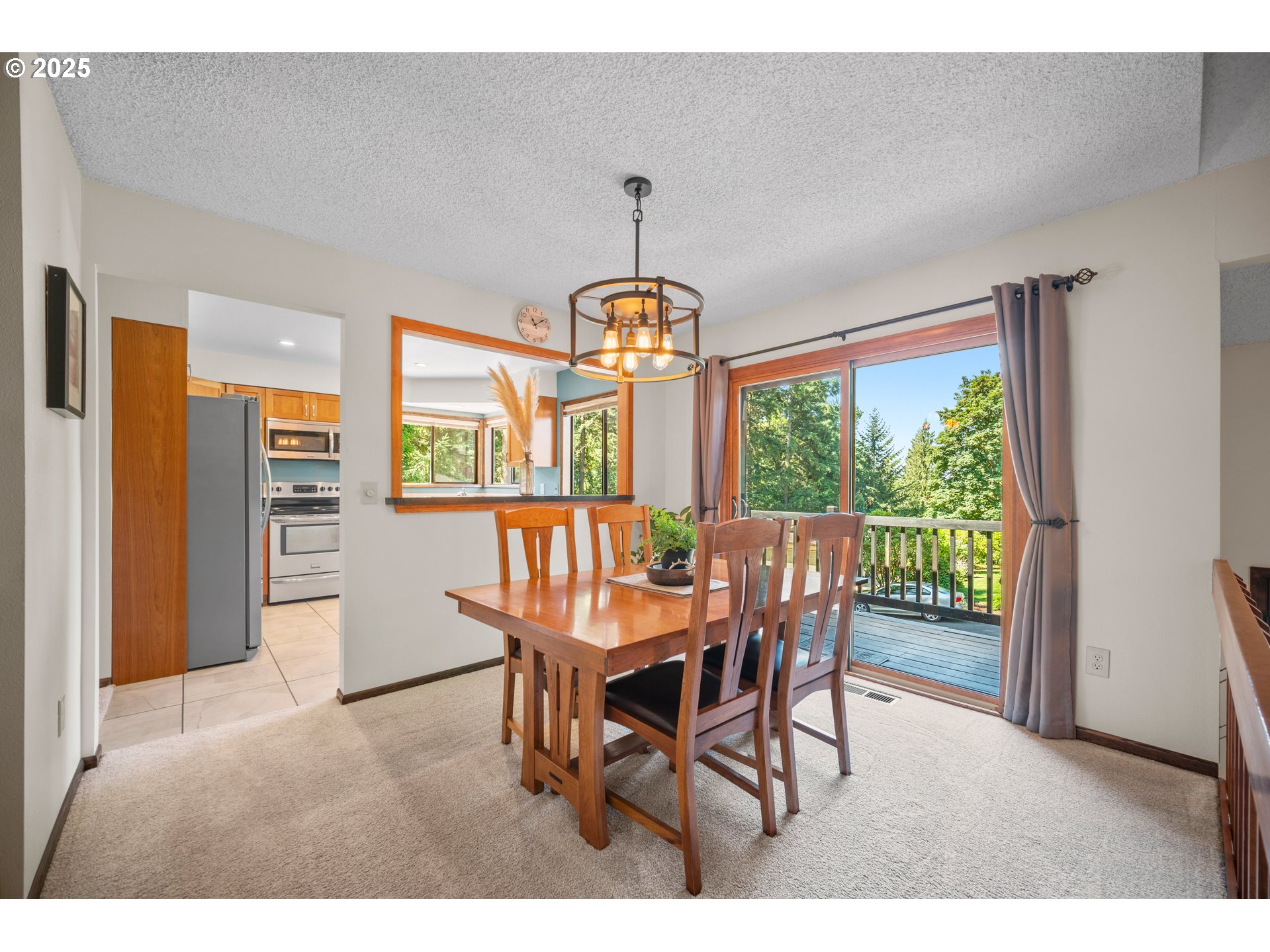 9420 Southeast Carnaby Way Happy Valley, OR 97086 - Photo 10 of 43 a dining room with furniture a chandelier and wooden floor