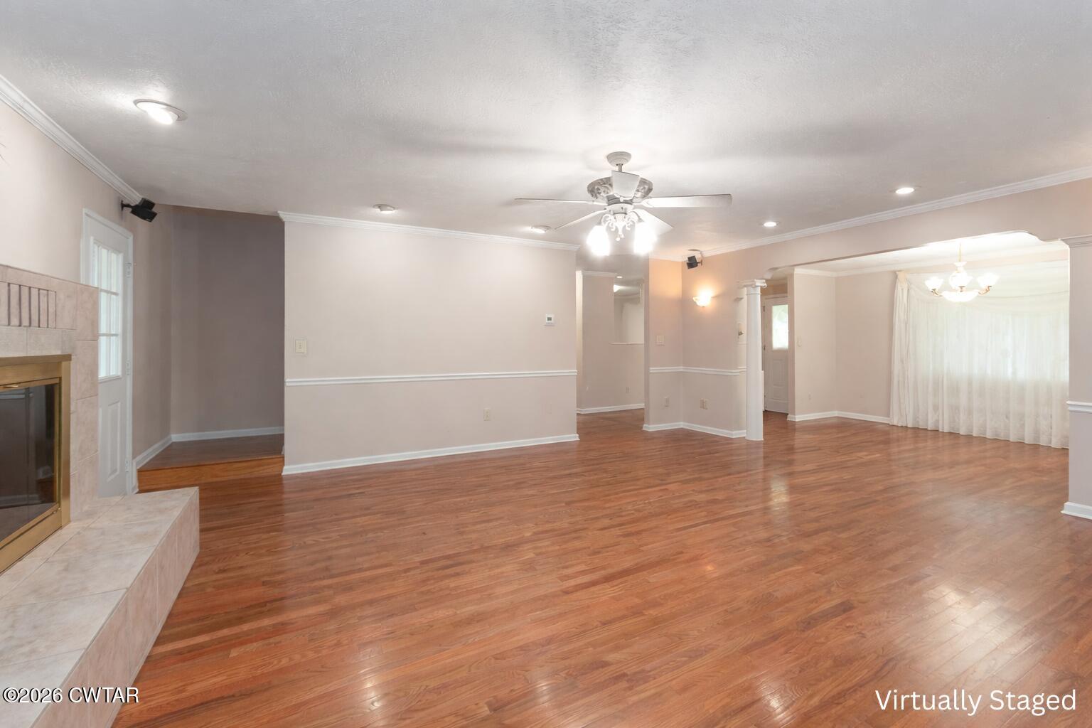 812 Pipkin Road Jackson, TN 38305 - Photo 11 of 62 an empty room with wooden floor and chandelier fan
