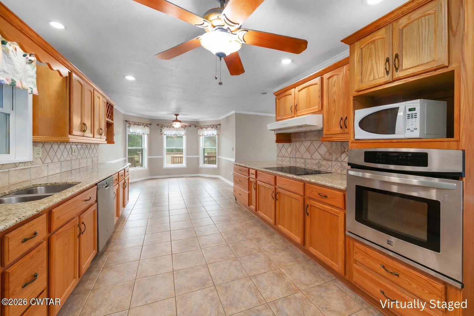 812 Pipkin Road Jackson, TN 38305 - Photo 18 of 62 a large kitchen with stainless steel appliances granite countertop a stove and a sink