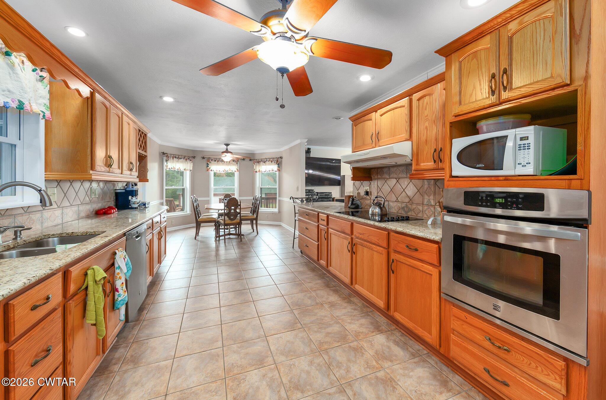 812 Pipkin Road Jackson, TN 38305 - Photo 19 of 62 a large kitchen with stainless steel appliances granite countertop a stove and cabinets