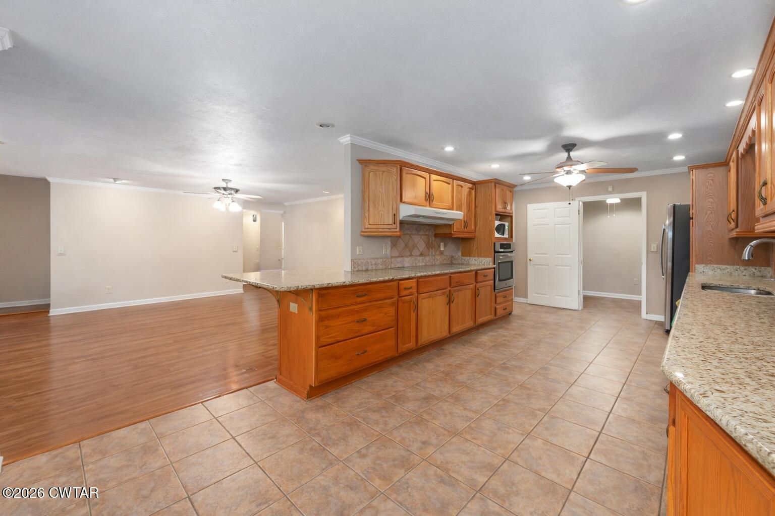 812 Pipkin Road Jackson, TN 38305 - Photo 20 of 62 a large bathroom with a granite countertop sink a toilet a mirror and vanity