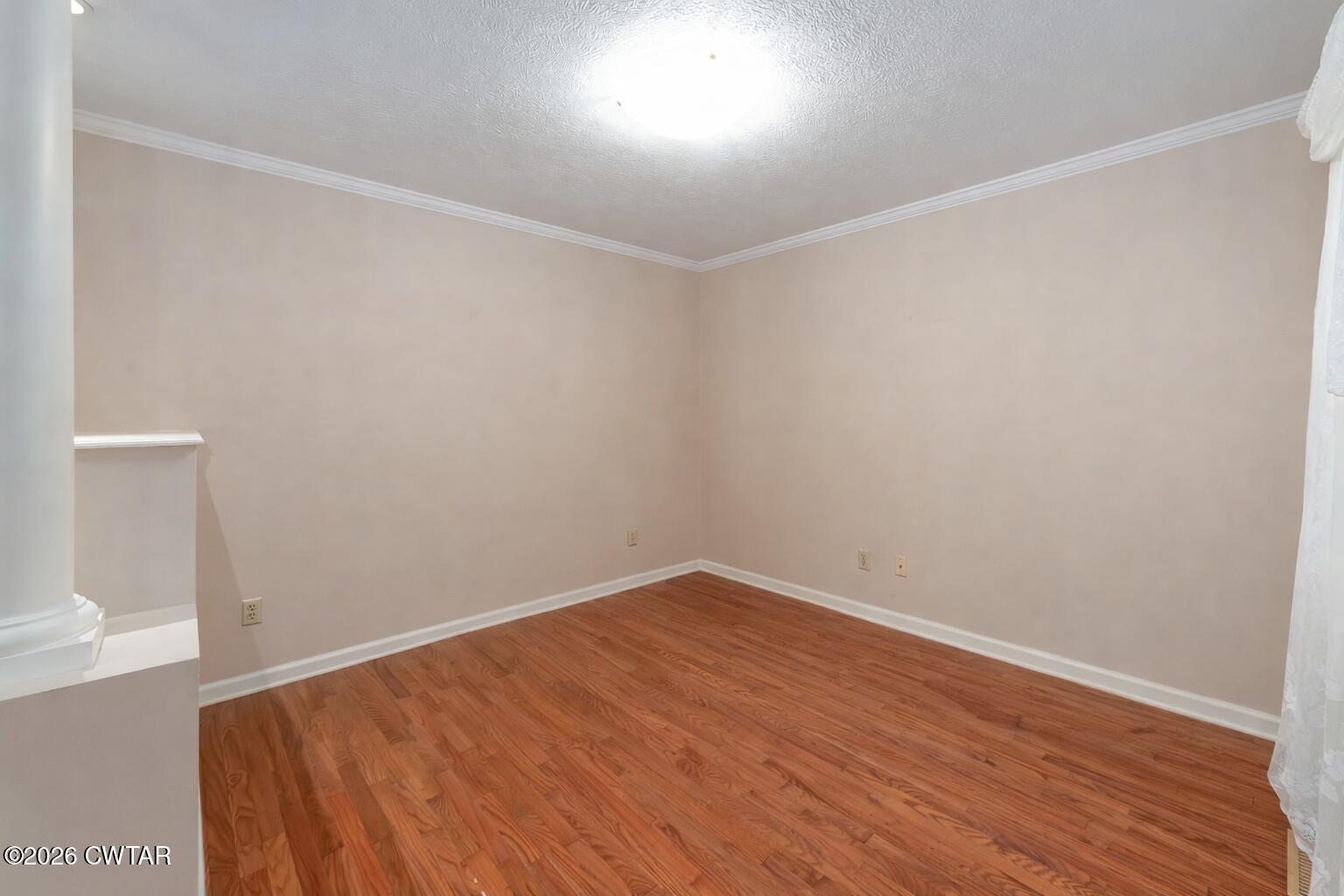 812 Pipkin Road Jackson, TN 38305 - Photo 26 of 62 an empty room with wooden floor and windows