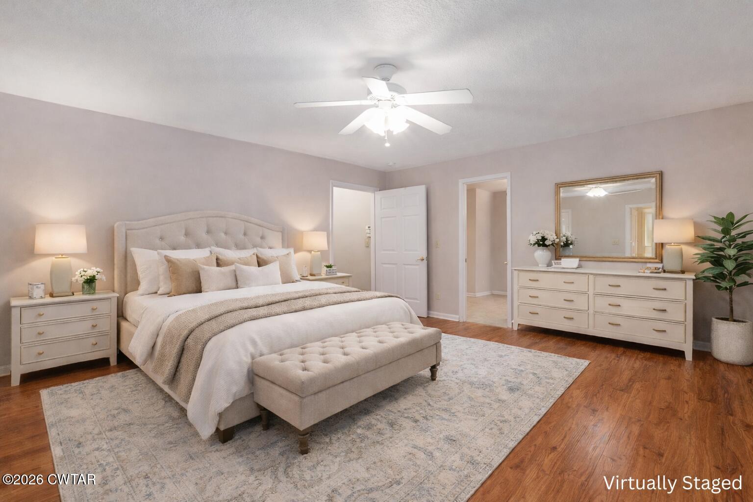 812 Pipkin Road Jackson, TN 38305 - Photo 27 of 62 a spacious bedroom with a bed a dresser and a chandelier