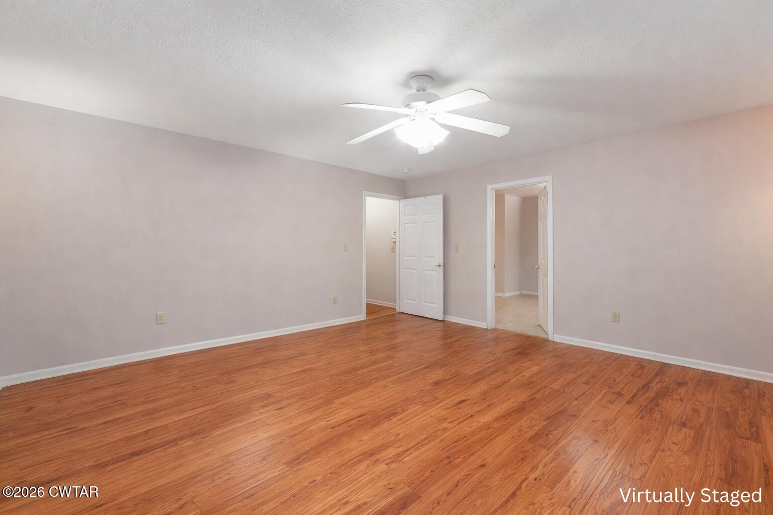 812 Pipkin Road Jackson, TN 38305 - Photo 30 of 62 a view of an empty room with wooden floor and a ceiling fan