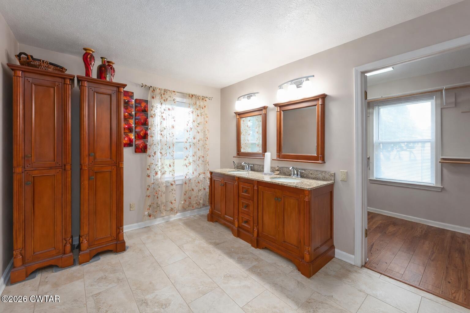 812 Pipkin Road Jackson, TN 38305 - Photo 32 of 62 a spacious bathroom with a double vanity sink and a mirror