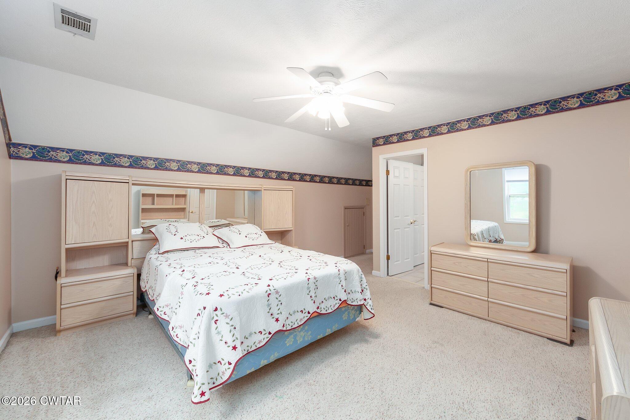 812 Pipkin Road Jackson, TN 38305 - Photo 41 of 62 a bedroom with a bed and a chandelier