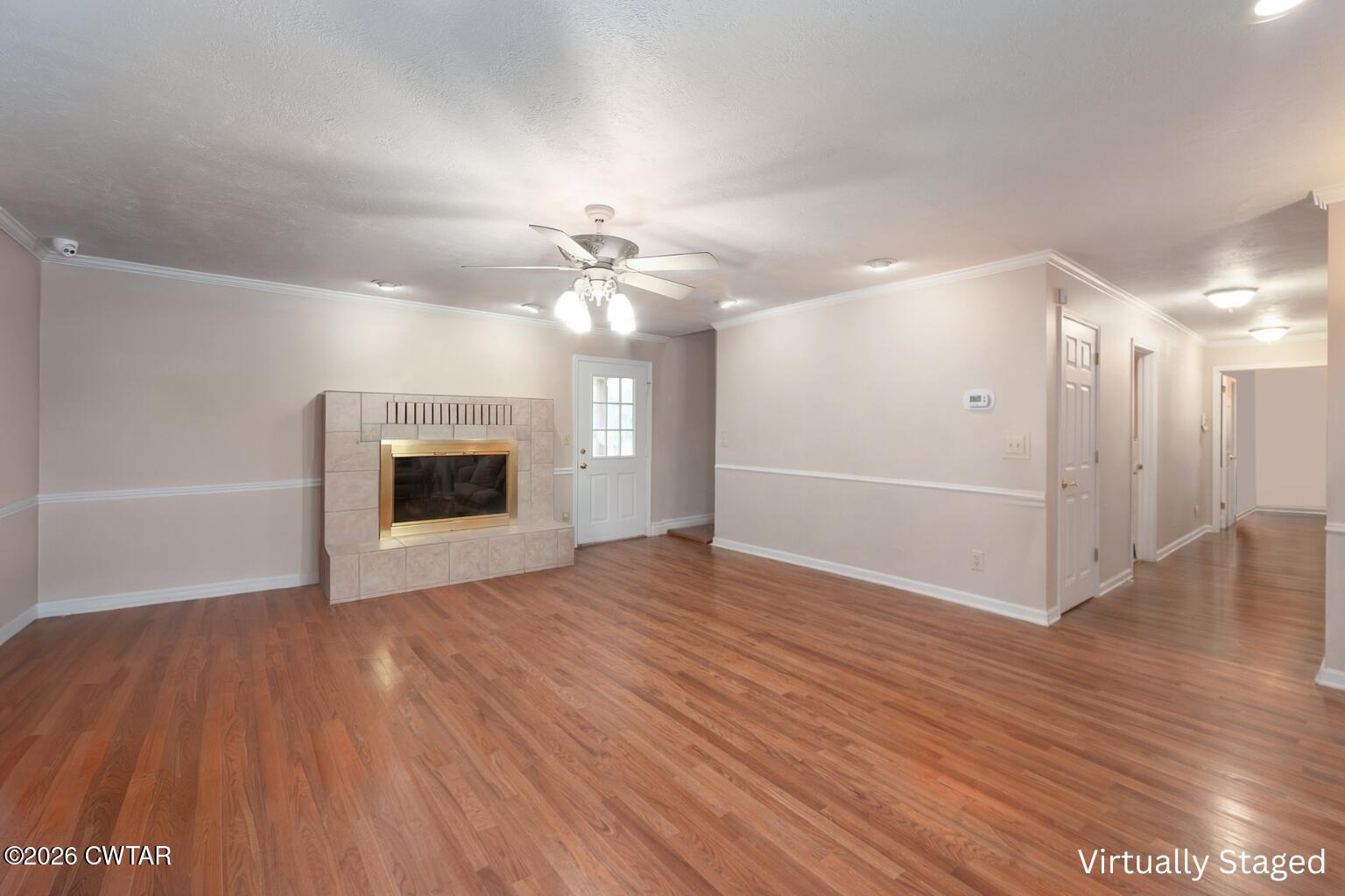 812 Pipkin Road Jackson, TN 38305 - Photo 5 of 62 a view of an empty room with wooden floor and a fireplace