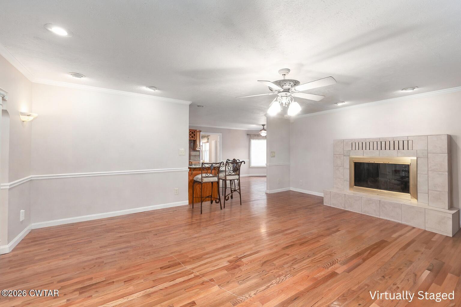 812 Pipkin Road Jackson, TN 38305 - Photo 8 of 62 a view of a livingroom with fireplace a ceiling fan and wooden floor