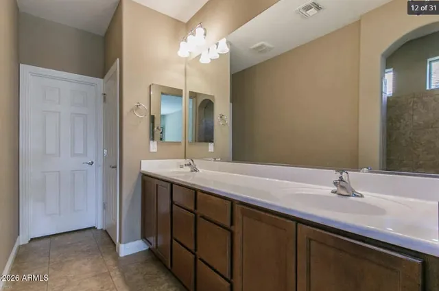 a bathroom with a double vanity sink and a mirror