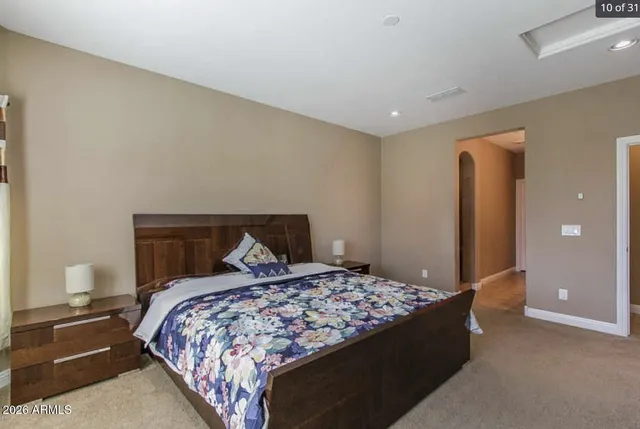 a bedroom with a large bed and lamp