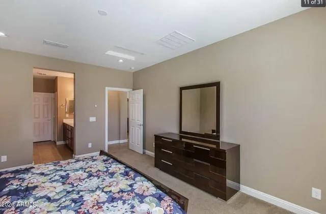 a bedroom with a bed and a dresser