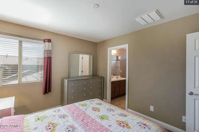 a bedroom with a bed and a dresser