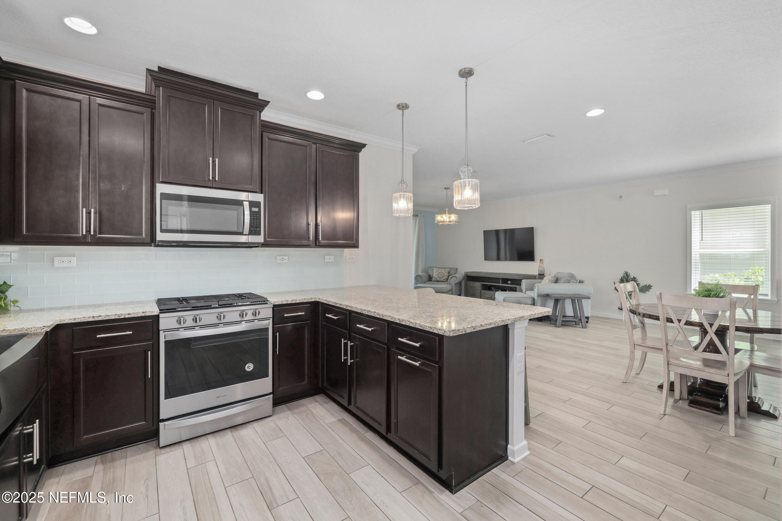 58 Strobe Court St. Augustine, FL 32095 - Photo 10 of 50 a kitchen with stainless steel appliances granite countertop wooden cabinets a stove top oven a sink and dishwasher