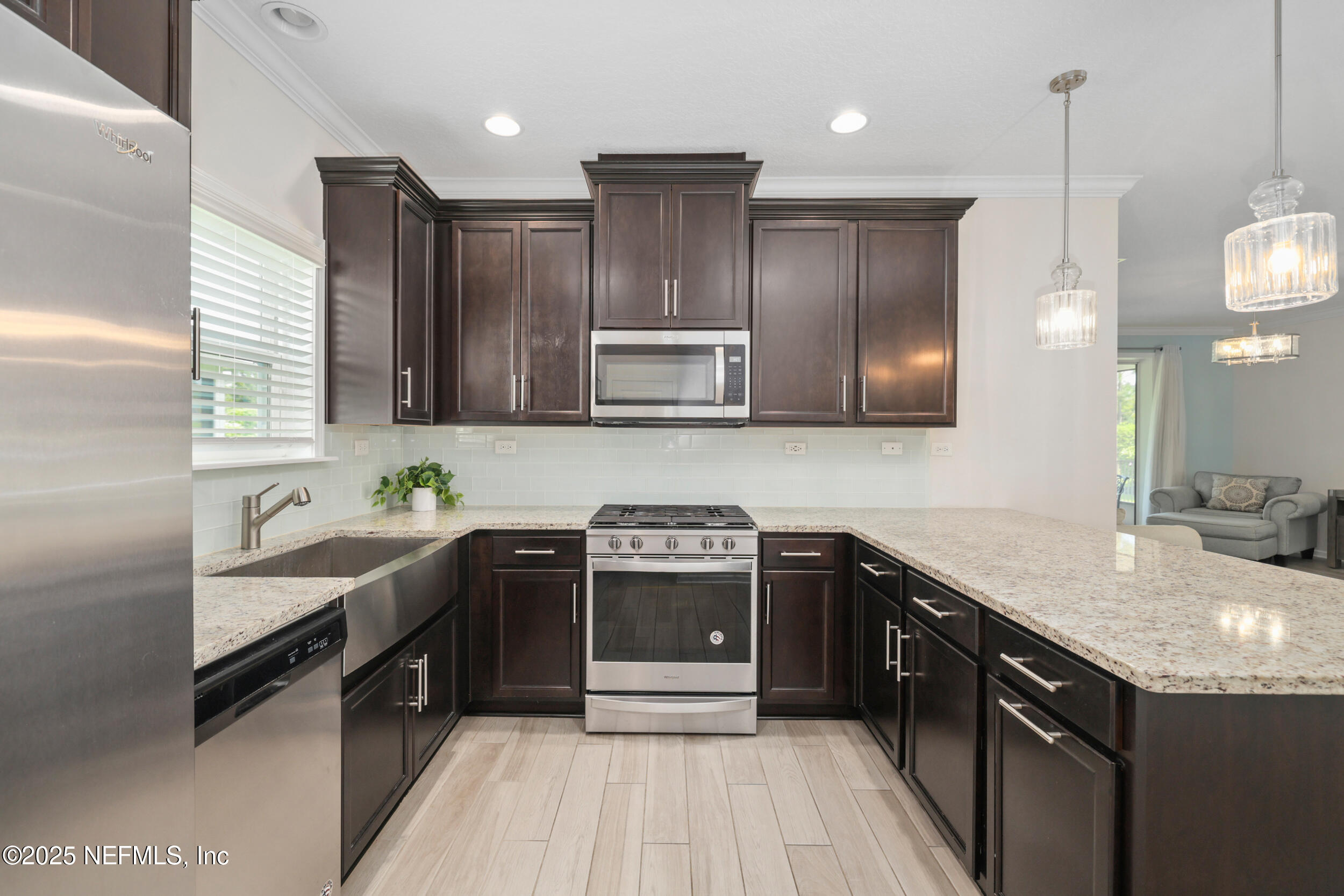 58 Strobe Court St. Augustine, FL 32095 - Photo 12 of 50 a kitchen with stainless steel appliances granite countertop a sink stove and refrigerator