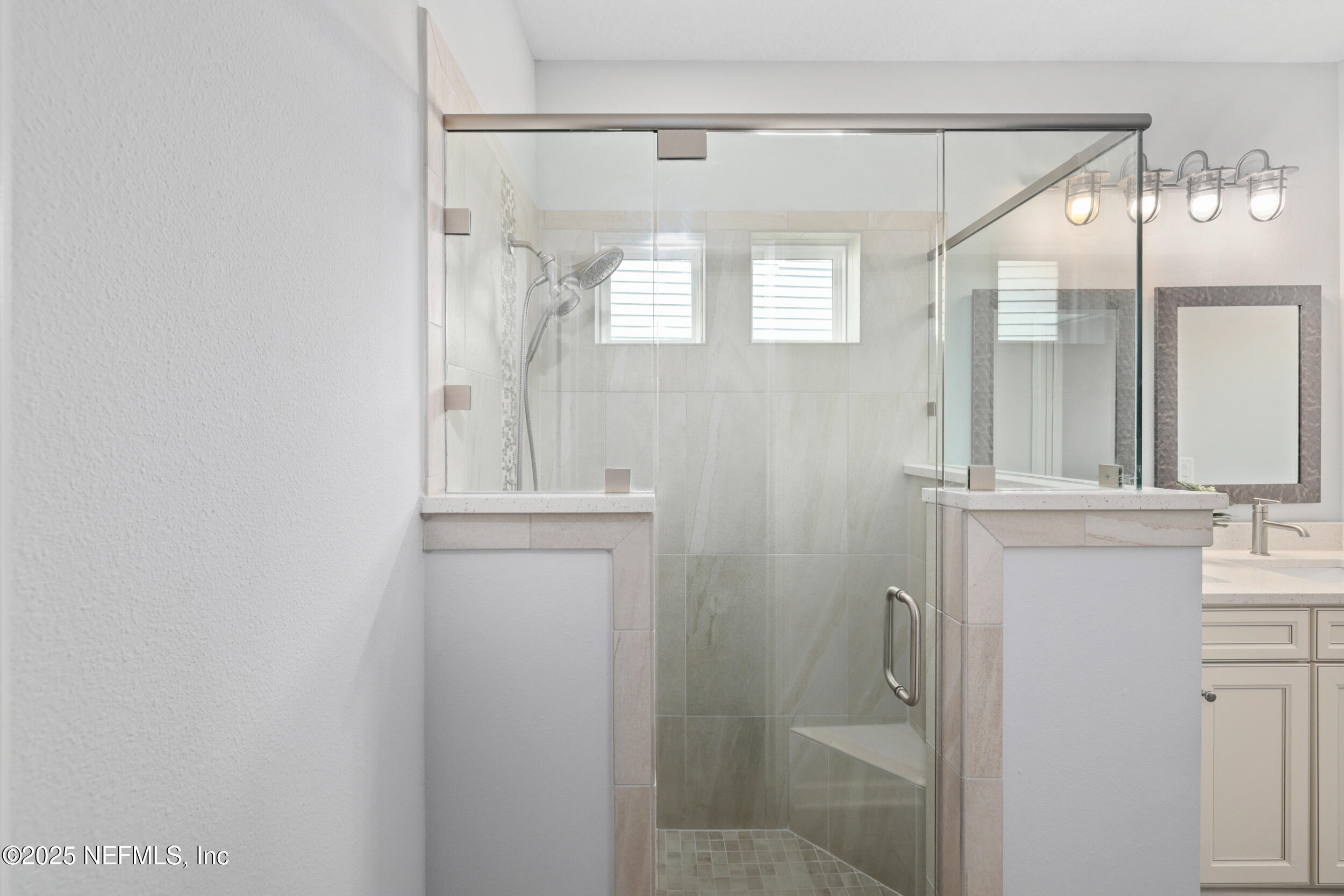 58 Strobe Court St. Augustine, FL 32095 - Photo 19 of 50 a bathroom with a bathtub a shower a sink and mirror