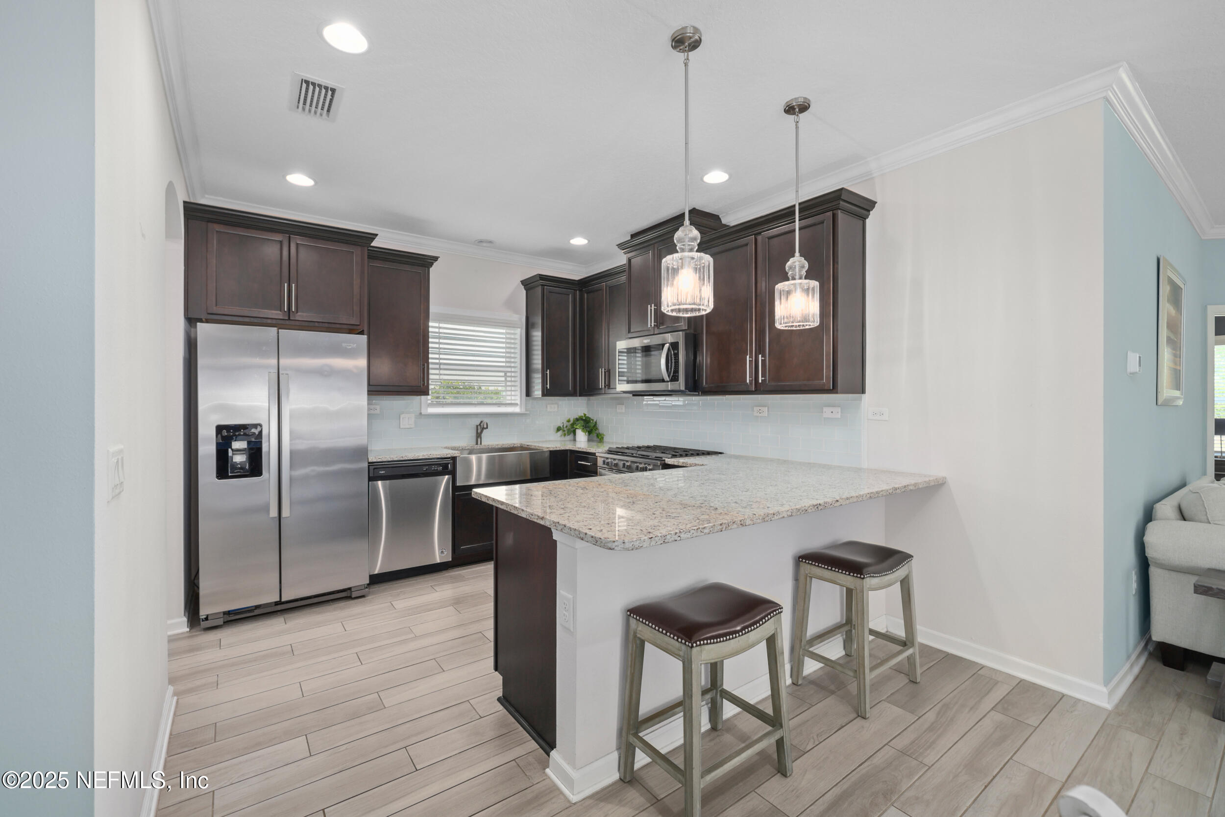 58 Strobe Court St. Augustine, FL 32095 - Photo 2 of 50 a kitchen with granite countertop a sink a counter space stainless steel appliances and cabinets