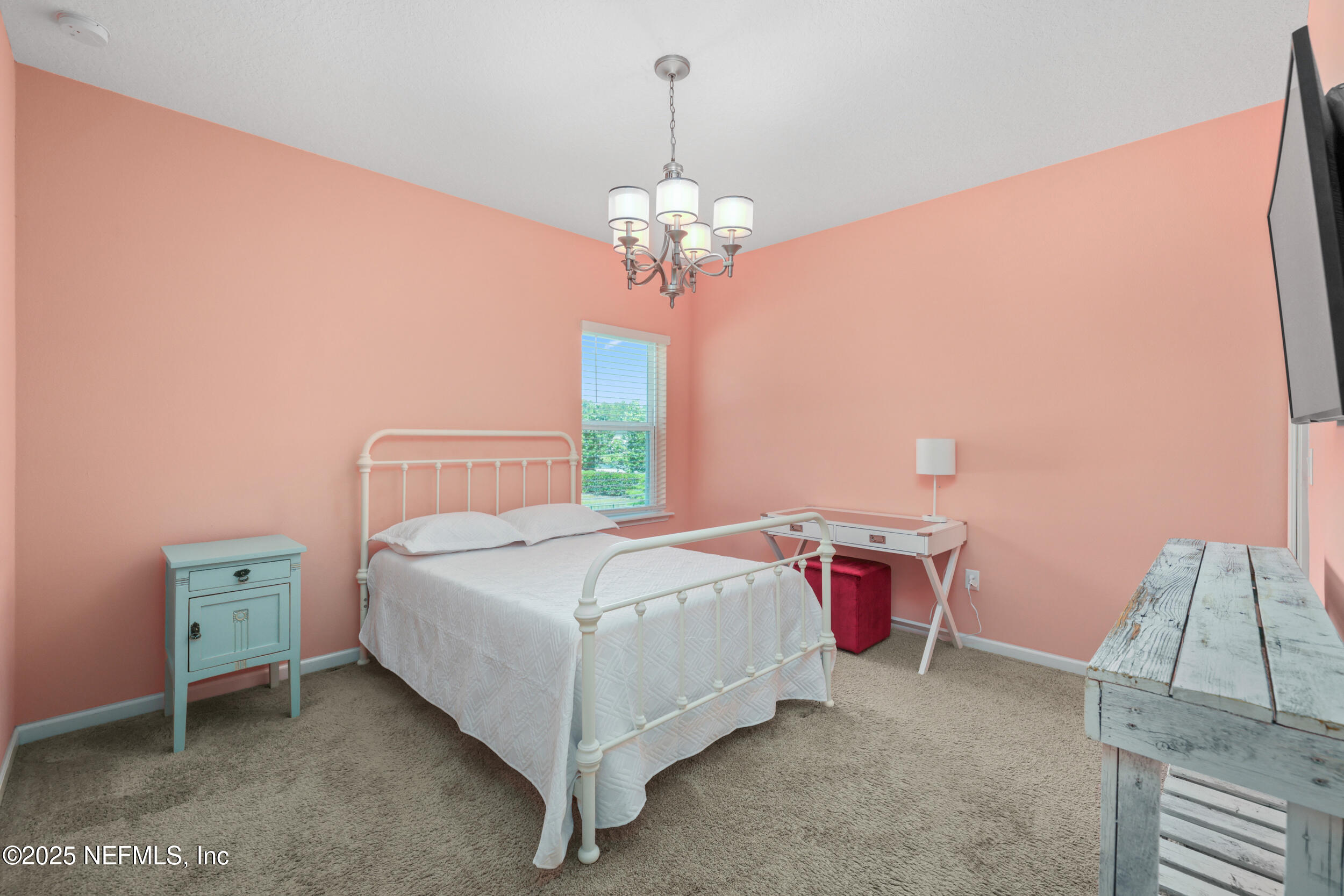 58 Strobe Court St. Augustine, FL 32095 - Photo 24 of 50 a bedroom with a bed and a chandelier