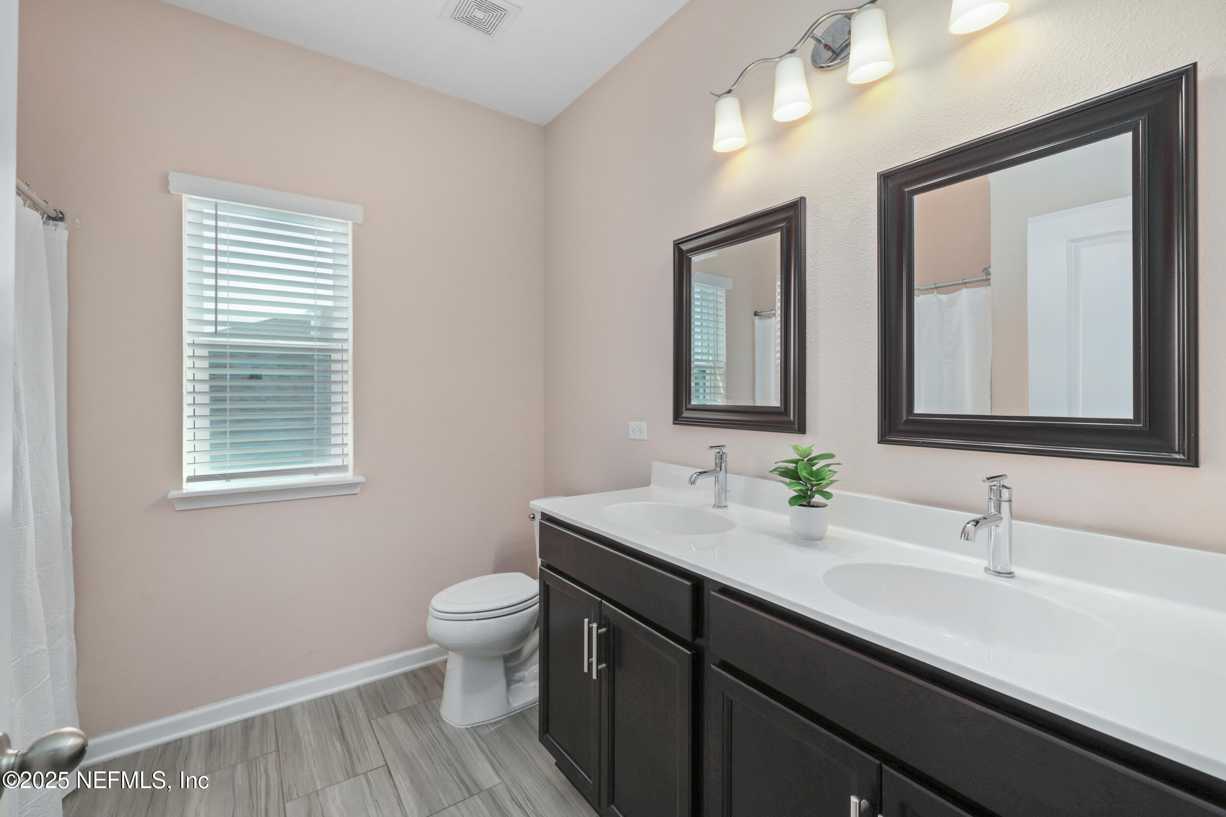 58 Strobe Court St. Augustine, FL 32095 - Photo 25 of 50 a bathroom with a double vanity sink toilet and a mirror