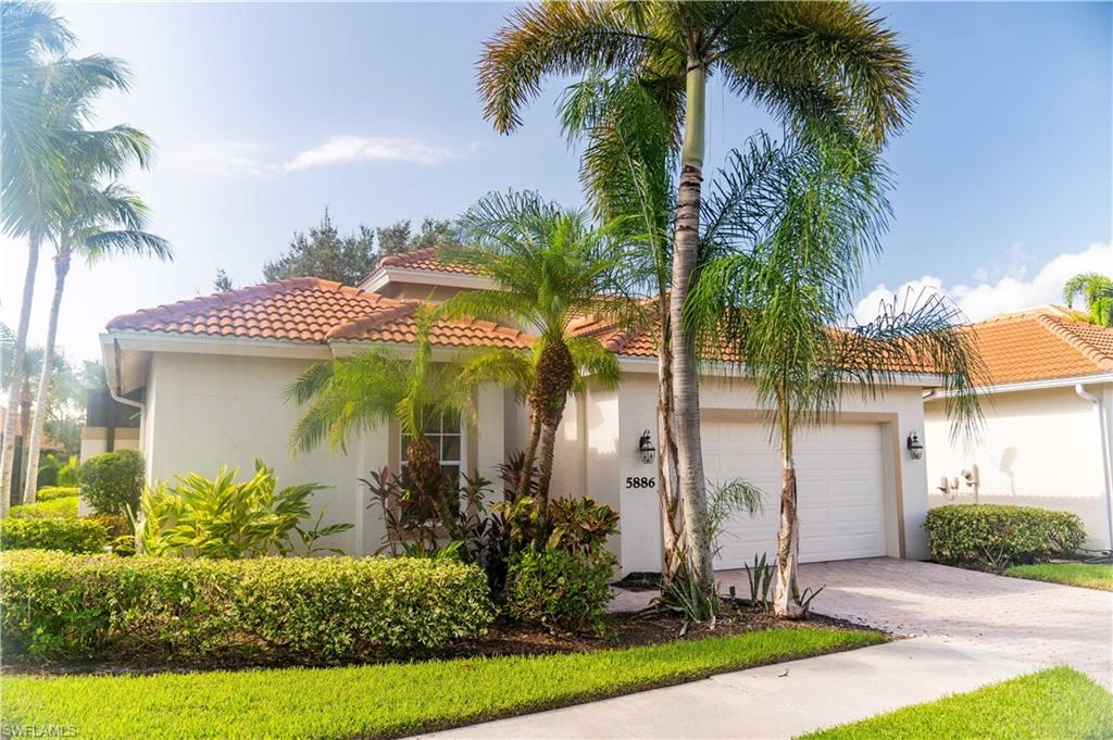 5886 Paradise Circle Naples, FL 34110 - Photo 1 of 19 Mediterranean / spanish-style home with a garage