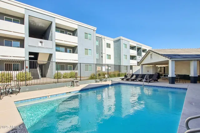 a house view with swimming pool and sitting space