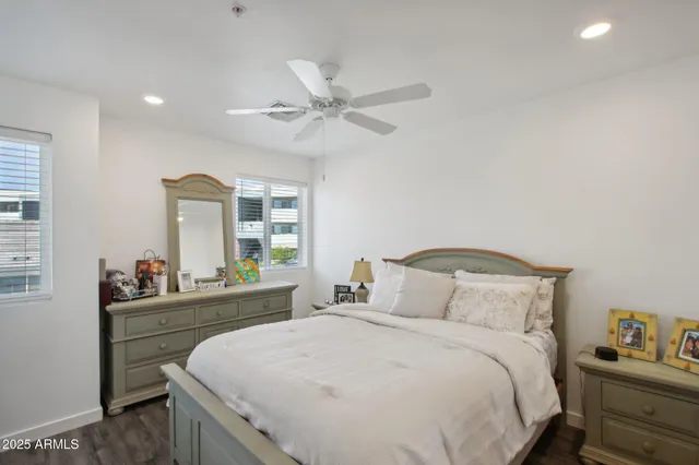 a bedroom with a bed and a large window