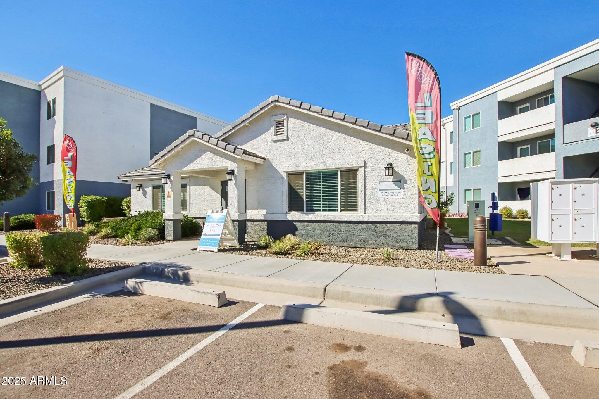 12925 West Greenway Road, Unit 5 El Mirage, AZ 85335 - Photo 14 of 30 a front view of a house with a patio