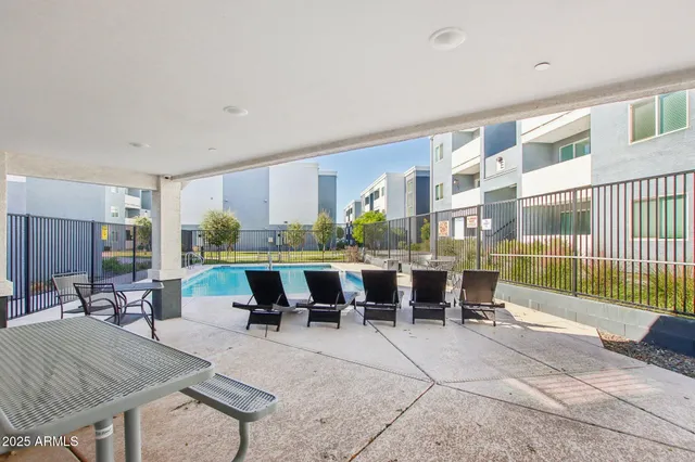 a living room with furniture a table and chairs